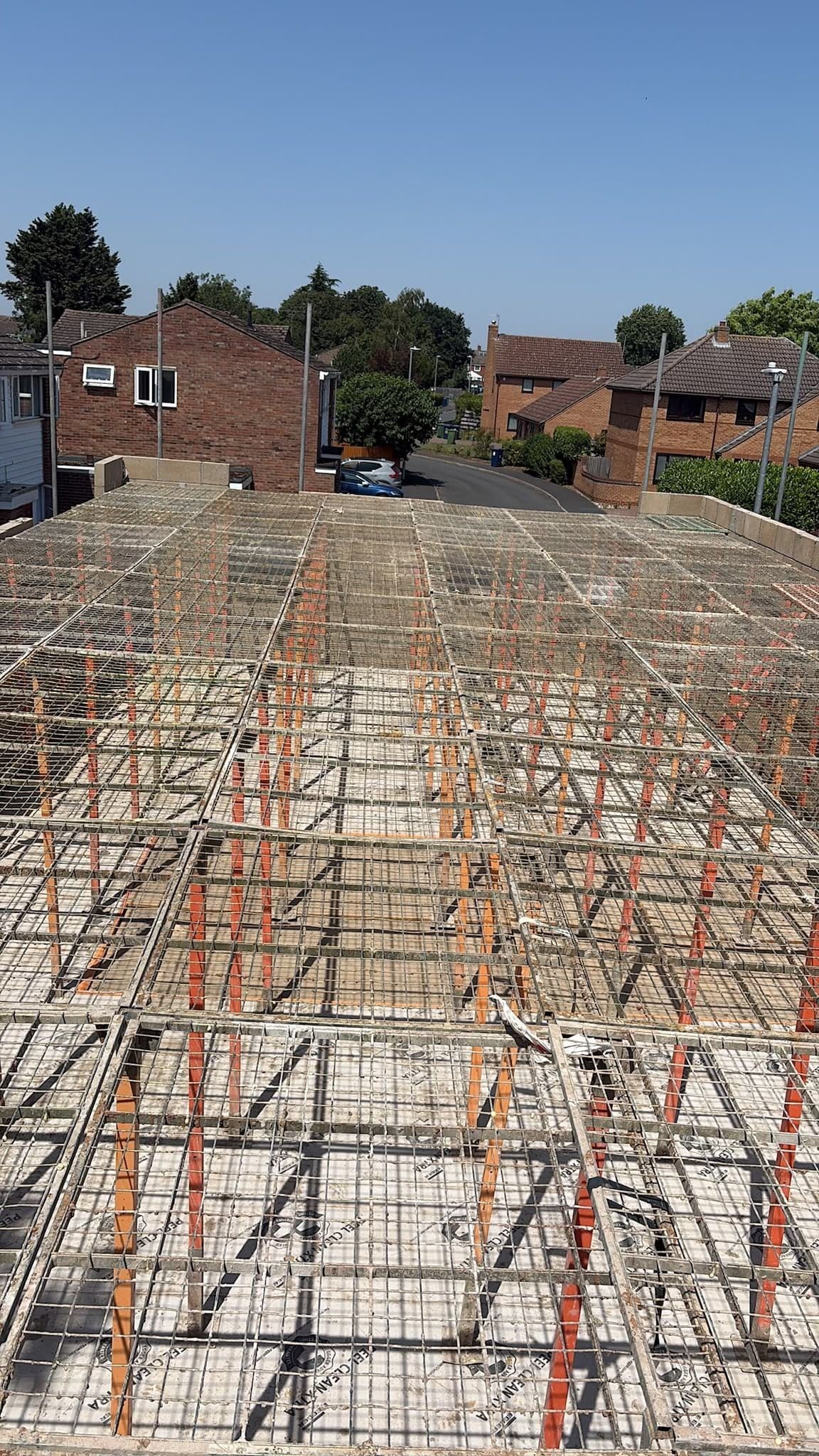 G-Deck Lite steel mesh decking across a floor void, houses beyond