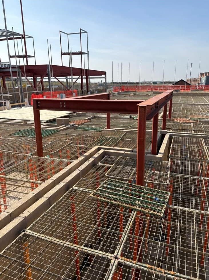 G-Deck Lite steel mesh decking installed inside a red steel-framed building